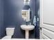 Stylish half bath featuring pedestal sink, oval mirror, and modern fixtures at 2039 West Hampton Dr, Canton, GA 30115