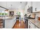 Modern kitchen with granite countertops, stainless steel appliances, and an open dining area at 2039 West Hampton Dr, Canton, GA 30115
