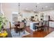 Features a kitchen island, stainless steel appliances, white cabinets, hardwood floors, and a dining area at 2039 West Hampton Dr, Canton, GA 30115