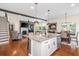 An open-concept layout featuring a kitchen island, stainless steel appliances, and a view of the living room at 2039 West Hampton Dr, Canton, GA 30115