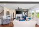 A bright living room features a cozy fireplace, with neutral furniture, and large windows for ample natural light at 2039 West Hampton Dr, Canton, GA 30115