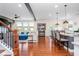 Open-concept living area boasts hardwood floors, kitchen island seating, and view to the living room at 2039 West Hampton Dr, Canton, GA 30115