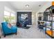 Bright workout room with modern exercise bike, shelving, and ample natural light from a large window at 2039 West Hampton Dr, Canton, GA 30115
