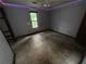 A bedroom with grey walls, dirty floors, and a window offering natural light at 2612 Ramblewood Ct, Acworth, GA 30102