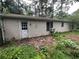 Exterior side view of a single story home showing a door with overgrown foliage at 2612 Ramblewood Ct, Acworth, GA 30102