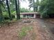 Single story home with lawn needing love and prominent fire pit feature at 2612 Ramblewood Ct, Acworth, GA 30102