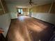 Empty living room with laminate floors and white wainscoting, lit by natural light at 2612 Ramblewood Ct, Acworth, GA 30102