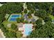 Aerial view of neighborhood pool, tennis courts, and clubhouse surrounded by lush trees at 1170 Spring Oak Way, Cumming, GA 30041