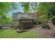 Backyard with a deck, a patio, a pergola, mature trees, and landscaping at 1170 Spring Oak Way, Cumming, GA 30041