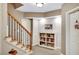 Basement stairway featuring wood railing and a built-in bookcase at 1170 Spring Oak Way, Cumming, GA 30041