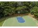 Aerial view of a basketball court in a wooded area surrounded by trees at 1170 Spring Oak Way, Cumming, GA 30041