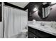 Stylish bathroom with a white shower curtain, dark walls, and a modern vanity at 1170 Spring Oak Way, Cumming, GA 30041