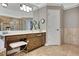 Bathroom featuring neutral tile, glass block shower, and ample cabinet space at 1170 Spring Oak Way, Cumming, GA 30041