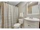 Neutral bathroom featuring a toilet, a sink with vanity, and a shower with curtain at 1170 Spring Oak Way, Cumming, GA 30041