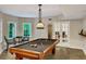Billiards room features tile floors, large windows, and refined light fixture at 1170 Spring Oak Way, Cumming, GA 30041