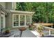 Backyard deck with gray wood, railing, patio table set, and foliage at 1170 Spring Oak Way, Cumming, GA 30041