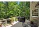 Backyard deck with a grill, patio table set, foliage, and forest views at 1170 Spring Oak Way, Cumming, GA 30041
