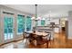 Light-filled dining room with hardwood floors and adjacent kitchen at 1170 Spring Oak Way, Cumming, GA 30041