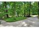 Circular driveway with a decorative lamppost, surrounded by mature trees, enhancing the property's charm at 1170 Spring Oak Way, Cumming, GA 30041