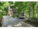 A beautiful home, nestled among mature trees, with a charming driveway at 1170 Spring Oak Way, Cumming, GA 30041