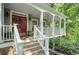 Inviting front porch with red double doors, offering a warm welcome to this beautifully designed home at 1170 Spring Oak Way, Cumming, GA 30041