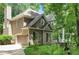 Side view of a home with a garage and well-maintained landscaping, blending curb appeal with functionality at 1170 Spring Oak Way, Cumming, GA 30041