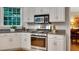 Well-appointed kitchen with stainless steel gas range and oven, granite countertops, and white cabinetry at 1170 Spring Oak Way, Cumming, GA 30041