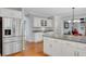 Spacious kitchen with island, stainless refrigerator, granite counters, and hardwood floors at 1170 Spring Oak Way, Cumming, GA 30041