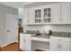 Kitchen with built-in desk, granite counters and white cabinets at 1170 Spring Oak Way, Cumming, GA 30041