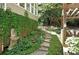 Landscaped pathway with lush greenery and stone steps alongside home's exterior at 1170 Spring Oak Way, Cumming, GA 30041