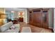 Open-concept living room featuring built-in cabinets and view into the dining room at 1170 Spring Oak Way, Cumming, GA 30041