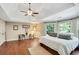 Large main bedroom featuring a tray ceiling, hardwood floors, and generous windows, creating a serene retreat at 1170 Spring Oak Way, Cumming, GA 30041
