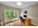 Bright home office featuring hardwood floors, large windows, and a comfortable workspace with a view at 1170 Spring Oak Way, Cumming, GA 30041