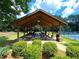 Outdoor pavilion with picnic tables, lighting, and adjacent BBQ grills, nestled in a green community park at 1170 Spring Oak Way, Cumming, GA 30041