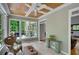 Cozy sunroom featuring wood ceiling, tile floors, and an abundance of natural light from the surrounding windows at 1170 Spring Oak Way, Cumming, GA 30041