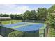 View of community tennis courts with blue and green surfaces and a black fence at 1170 Spring Oak Way, Cumming, GA 30041