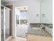 Bathroom with shower and granite vanity top with access to the bedroom with city views at 3324 Peachtree Ne Rd # 2518, Atlanta, GA 30326