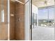 Bathroom with shower and tan tile and access to the bedroom with city views at 3324 Peachtree Ne Rd # 2518, Atlanta, GA 30326