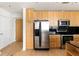 Contemporary kitchen featuring stainless steel appliances, light wood cabinets, and black backsplash at 3324 Peachtree Ne Rd # 2518, Atlanta, GA 30326