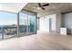 Modern living room with hardwood floors, balcony access, and views of the city skyline at 3324 Peachtree Ne Rd # 2518, Atlanta, GA 30326