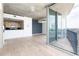 Open-concept living space with hardwood floors, a kitchen island, and access to the balcony overlooking the city at 3324 Peachtree Ne Rd # 2518, Atlanta, GA 30326