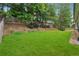 Wide backyard with well maintained lawn and wooden fence at 430 La Perla Dr, Sugar Hill, GA 30518