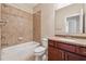 Bathroom with tiled shower/bath, granite vanity top and dark wood cabinets at 430 La Perla Dr, Sugar Hill, GA 30518