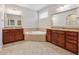 Bathroom with large vanity, granite countertops, and a soaking tub at 430 La Perla Dr, Sugar Hill, GA 30518