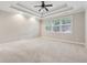 Spacious bedroom with trey ceilings, fan, and carpet at 430 La Perla Dr, Sugar Hill, GA 30518