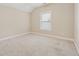 Bright bedroom with a large window, neutral carpet, and ample natural light at 430 La Perla Dr, Sugar Hill, GA 30518