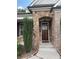 Stone porch entrance with a craftsman-style wooden front door at 430 La Perla Dr, Sugar Hill, GA 30518