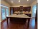 Spacious kitchen with a large island, stainless steel appliances, and dark wood cabinetry at 430 La Perla Dr, Sugar Hill, GA 30518