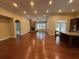 Bright and open living room with hardwood floors, recessed lighting, and stone fireplace at 430 La Perla Dr, Sugar Hill, GA 30518