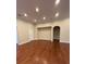 Open living space with hardwood flooring and neutral paint, providing a bright and airy atmosphere at 430 La Perla Dr, Sugar Hill, GA 30518